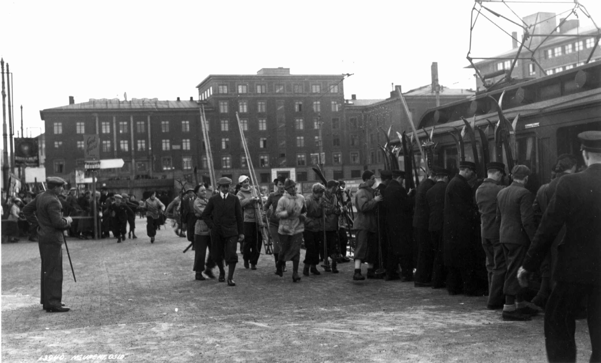 Transport av skiløpere på Holmenkollbanen, Oslo. Skiløpere fester skiene på trikkevognen på Majorstuen.