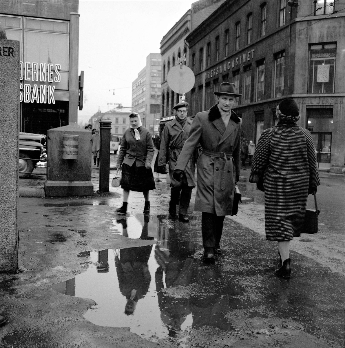 Søle i Oslo, vårløsning i gatene. Youngstorget der Torggata krysser Youngs gate. Folkets Hus i bakgrunnen til venstre, med Bøndernes Bank på hjørnet. Mars 1959