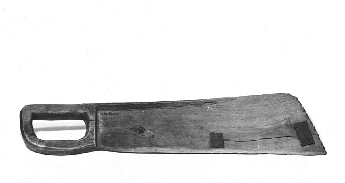 Skäktkniv, sjecktträ, av trä, lagad med järnband. Rester av mörk bets. På ryggen inskuret: 1845.
