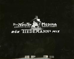 Lysskilt, reklame for Tiedemanns Blue Master og Medina sigar