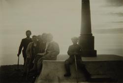 Familiegruppe foran et minnesmerke