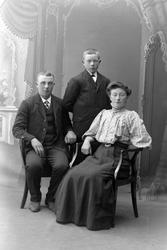 Studioportrett av tre søsken.