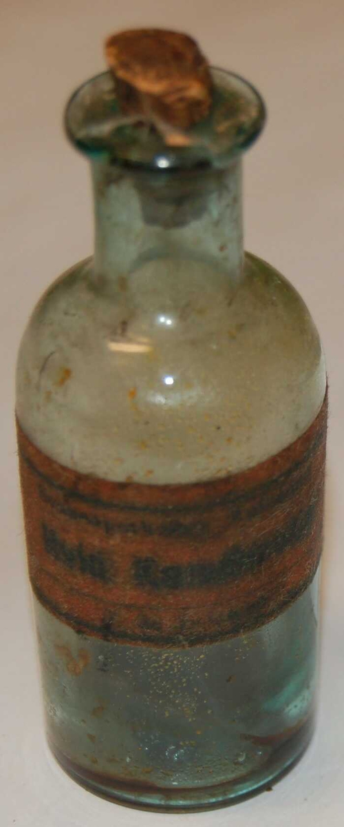 Rund sylindrisk flaskeformet medisinglas.