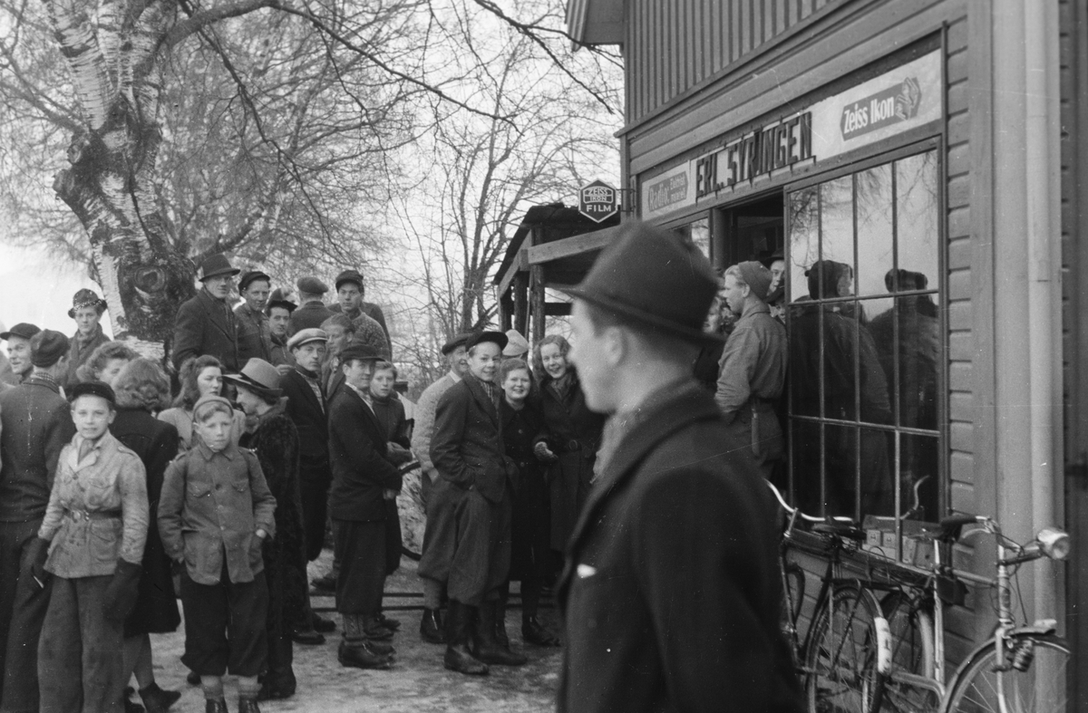 Kø ved Syringens butikk. Filmsalg påsken 1945. Leiret, Elverum.