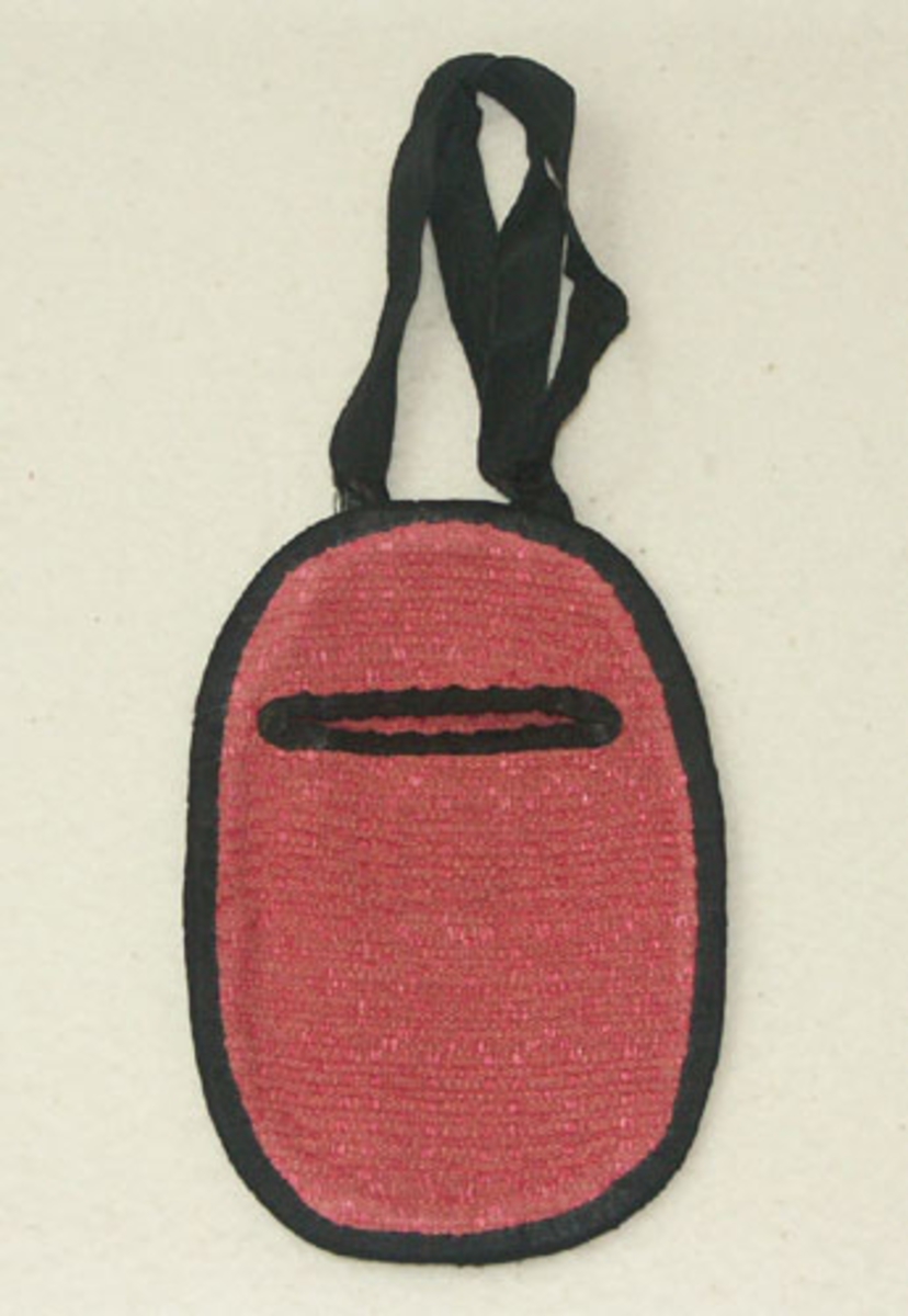 Kjolsäck till Sunnerbodräkt sydd i rosa daldrällstyg, samma tyg har använts till livstycken till Sunnerbodräkt, kjolsäcken är kantad med svart ripsband troligen av siden som också använts till handtaget. Kjolsäcken har använts till uthyrning.
