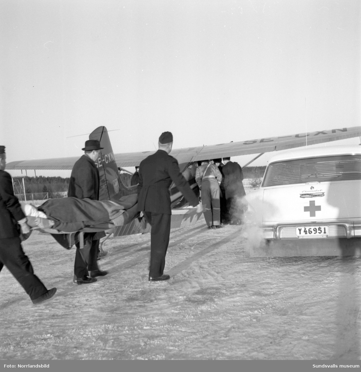 Sjuktransport från Midlanda med Gunnar "Spökis" Andersson. En norrman som skadat sig i ett fall ner i ett lastrum på en båt i hamnen ville hem till julen. Han var förlamad från bröstkorgen och neråt och den enda flygtransport som kunde ta honom till Bodö och Norge var "Spökis" Anderssons plan. Flygningen blev dock dramatisk eftersom det uppstått isbildadning på vingarna då planet befann sig vid norska gränsen. Man fick därför återvända till Sverige för nödlandning på isen vid Arjeplog. Där var det 1, 5 meter snö och en besvärlig frakt till sjukstugan berättar Bo Gert Lundgren (17 år och tillfälligt insatt som sjukvårdare) endast iförd lågskor och kostymbyxor. På radion hade man efterlyst besättningen eftersom man befarade att de hade störtat.