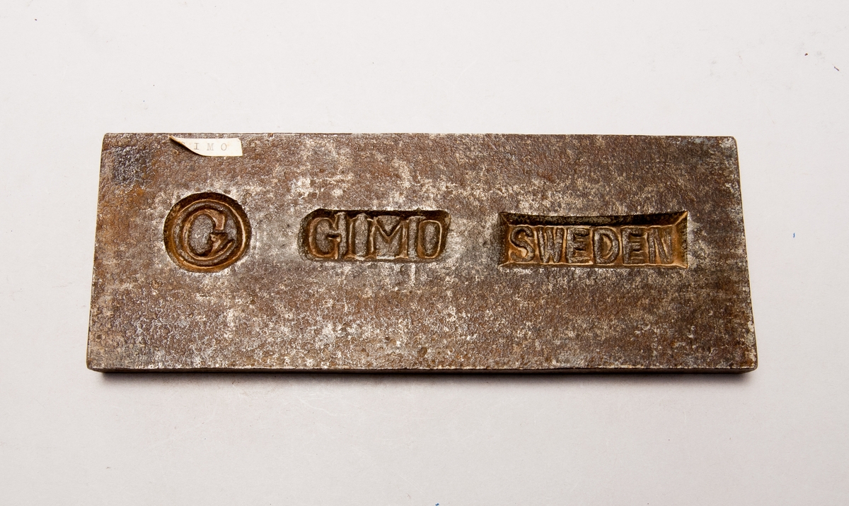 Järnstämpel från Gimo. Stämpeln är ett stort "G". Har texten "Gimo Sweden" på sig.