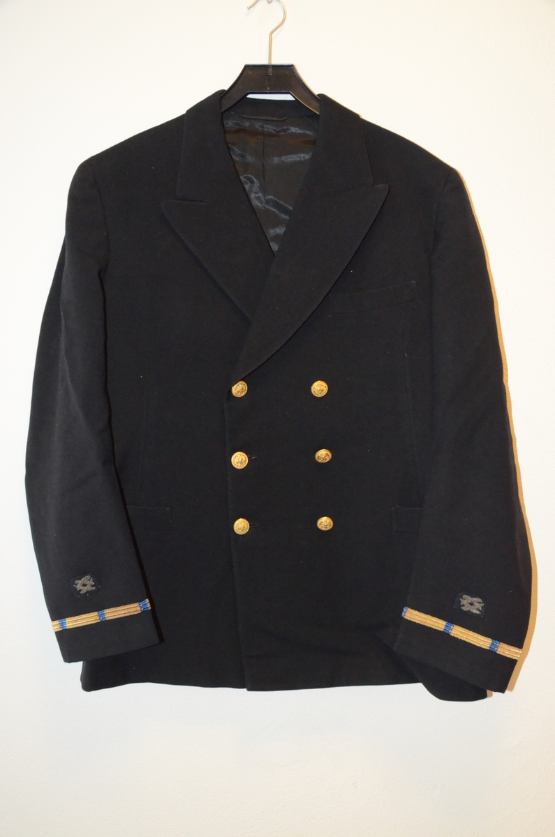 Marineuniform fran den amerikanske marinen, bestående av jakke, bukse, en uniformslue med skygge og en båtlue.