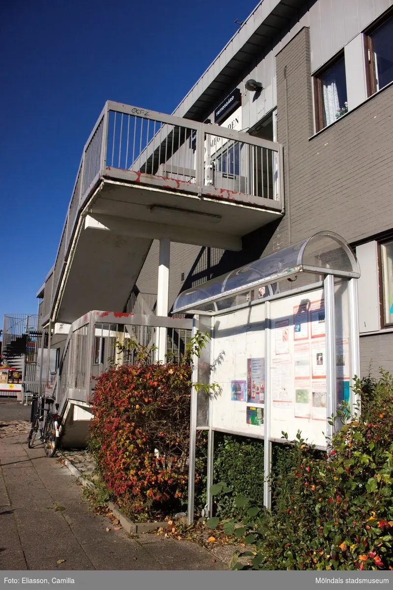 Huset Almåsgången 1 i Lindome centrum den 4 oktober 2016. Trappa och entré till Bio Etage och fritidsgården Lindomegården. Byggnadens fasad vetter mot söder. En anslagstavla är uppstalld på utsidanav byggnaden.