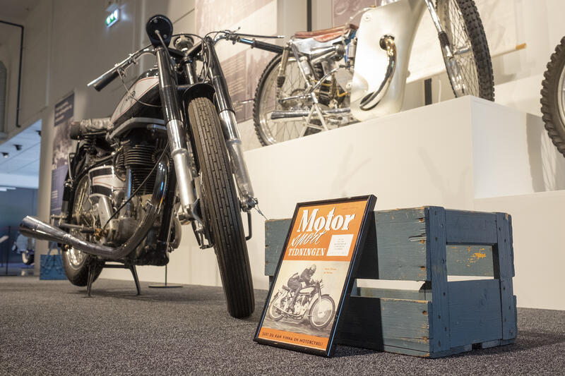 Motorsykler og forside av et magasin stilt ut på Norsk kjøretøyhistorisk museum.