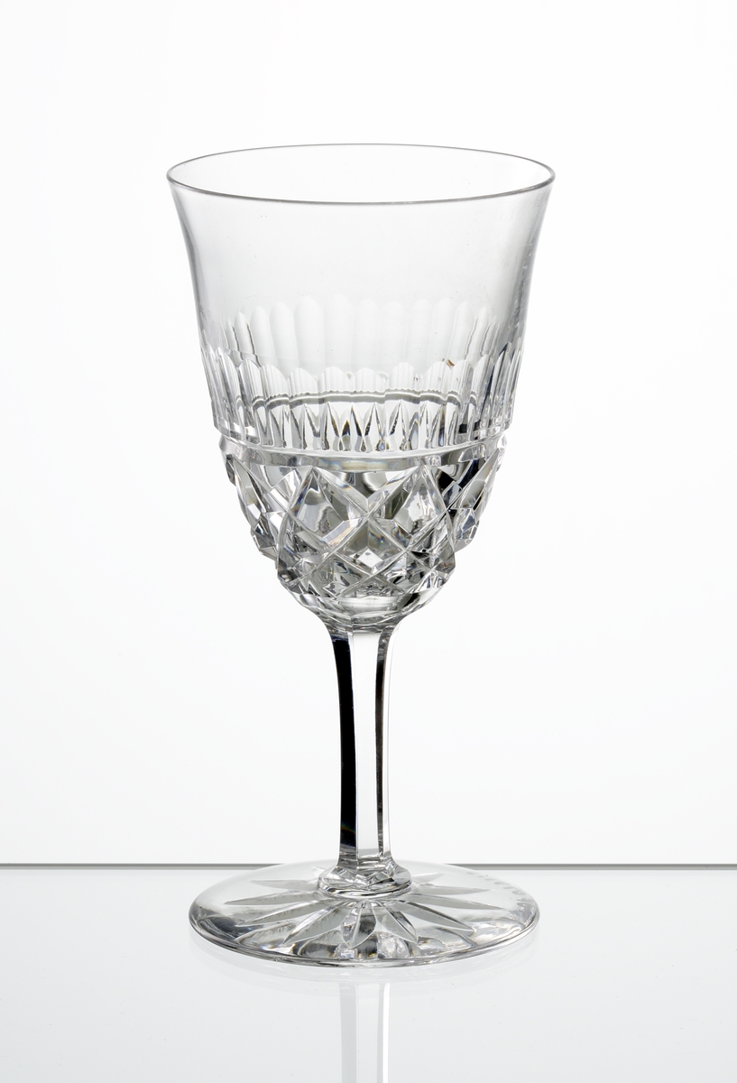 Design: Okänd. 
Portvinsglas med lätt klockformad kupa, skärslipad nedre del med olivslipad bård. Fasettslipat ben. Fot med skärslipad
stjärna i botten.