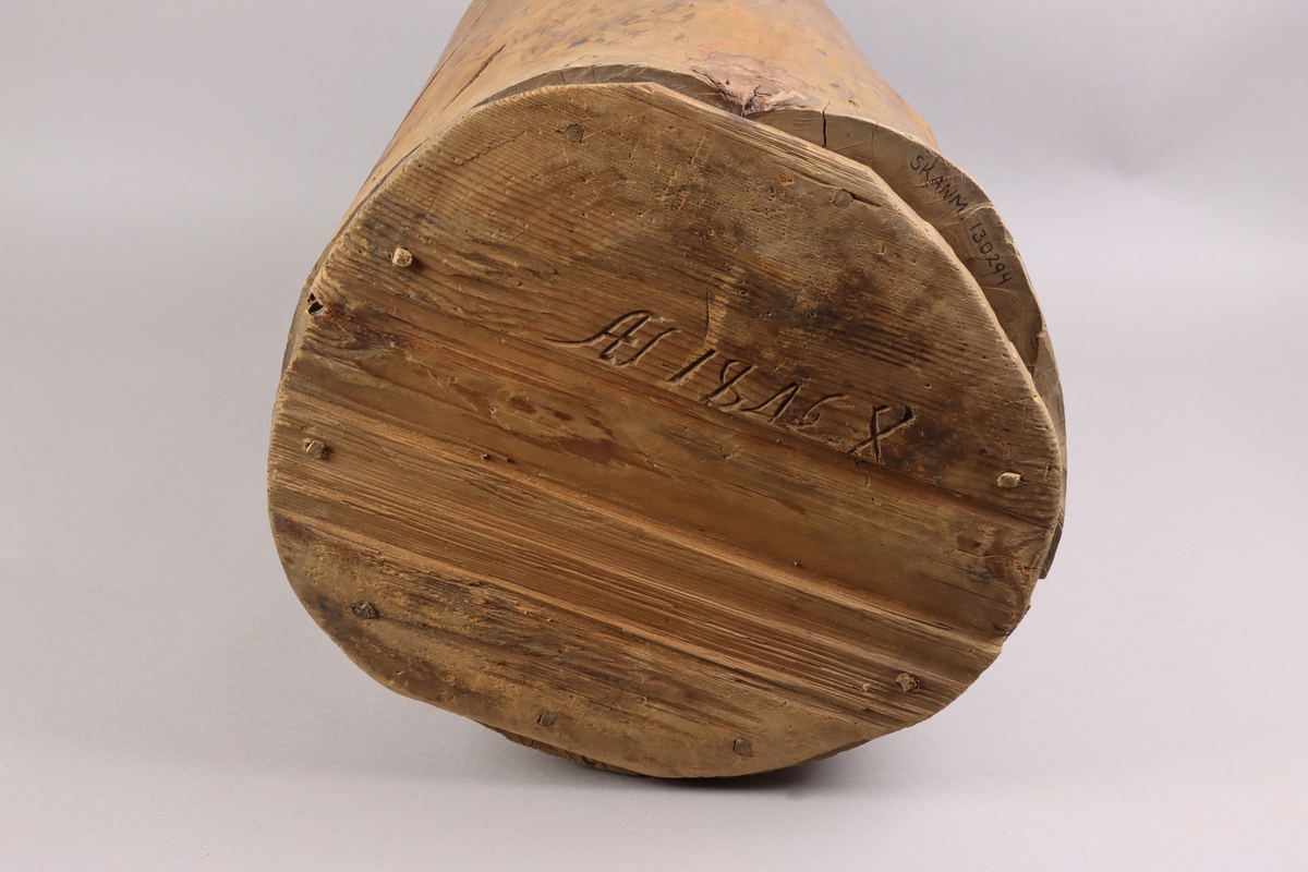 Kärl av trä konstruerad av urholkad stock. Utförd i ett stycke med utanpåliggande falsad botten. Botten av furu fastsatt med snedställda träpluggar. Genomgående spricka. Signatur och datering inskuren i botten: "AS 1846" följt av ett bomärke.