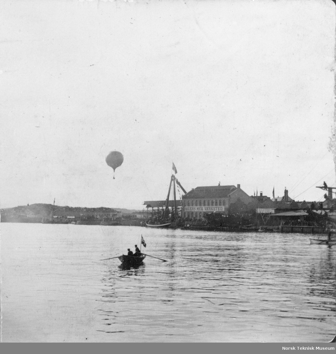 Robåt foran Akers Mek, luftballong i bakgrunnen. Fra Cettis ballongoppstigning 1890
