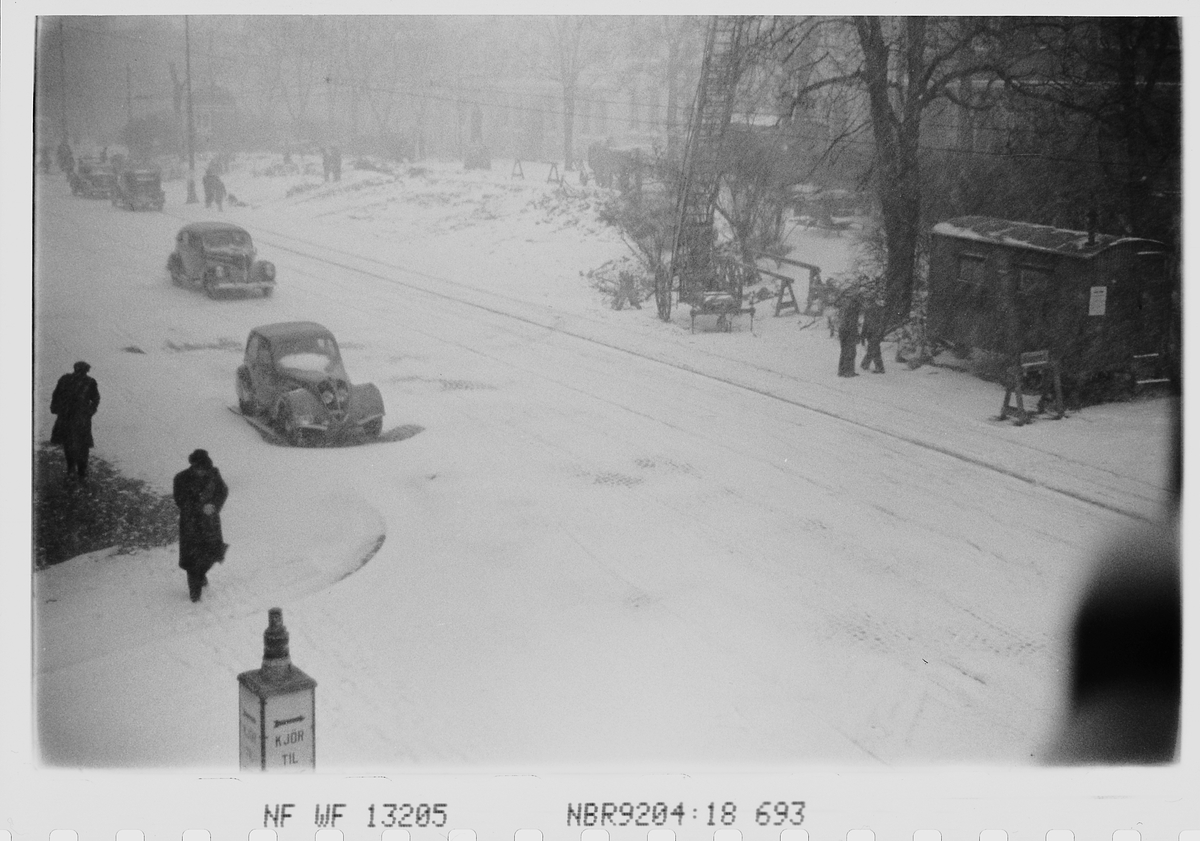 Personer og trafikkaos i snøen i Oslo sentrum. Fotografert 1940.