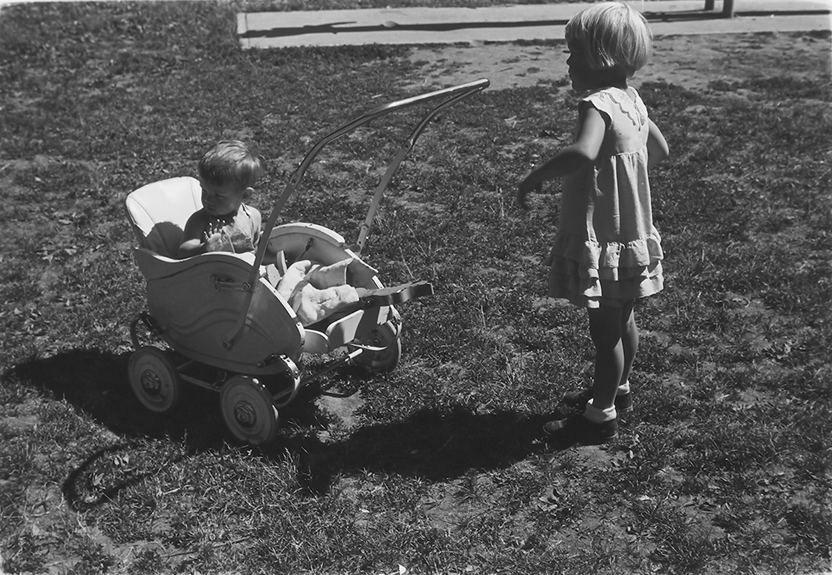 Pike med gutt i barnevogn i antatt Frognerparken, Oslo. Fotografert 1940.