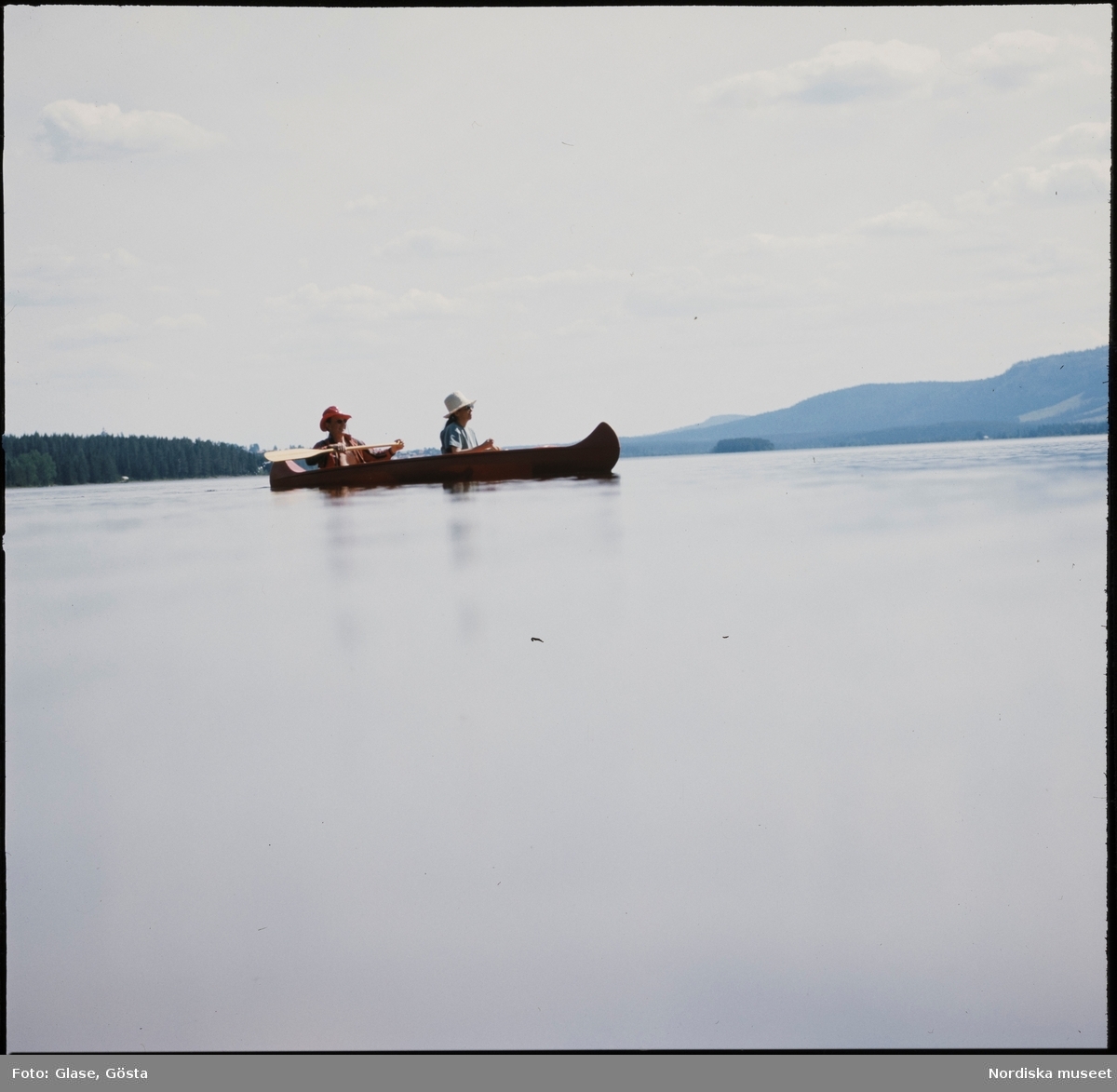 Två kvinnor paddlar kanot i Klövsjön.