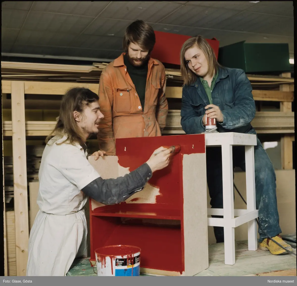 Ungdomar bygger och målar möbler.