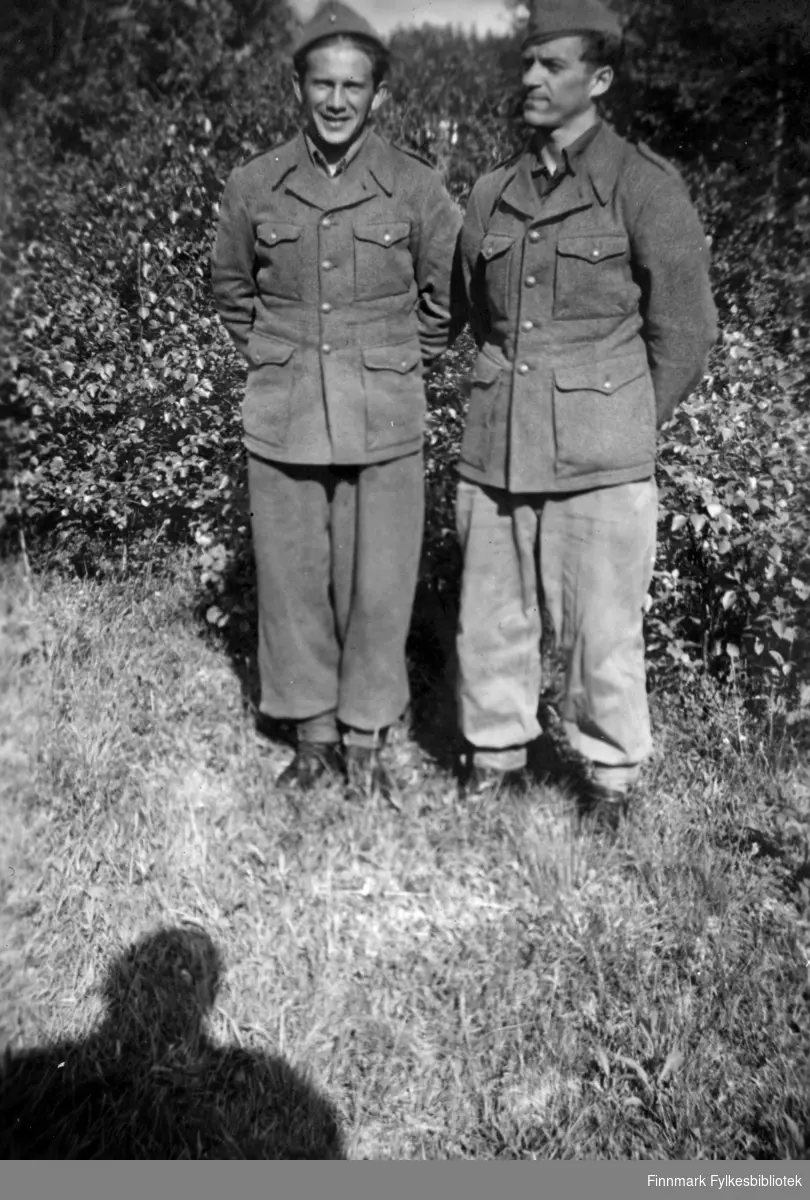 Martin Seljemo fra venstre, og Arne Mortensen kledt i uniformer. Bildet er tatt ute, på Drevjamoen i 1952