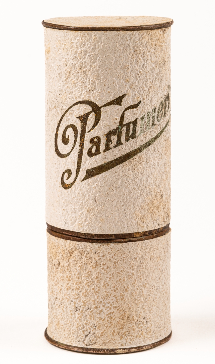 Parfymask i papp, cylinderformad, i glansigt vitt papper med guldfärgad text "Parfumerie".
