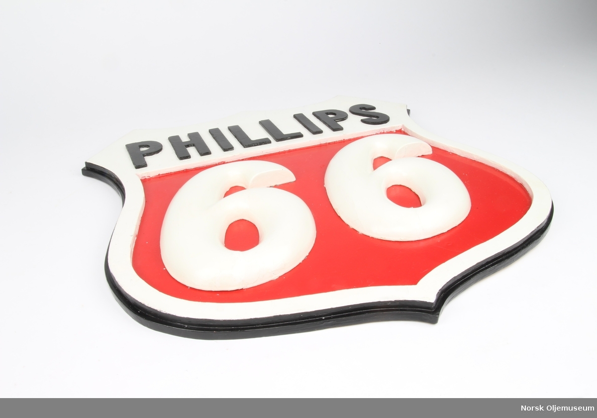 Skjoldformet skilt med relieffdekor. Skiltet ligner på Phillips sin logo.