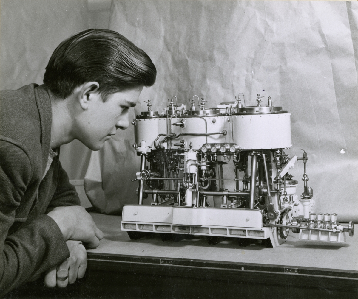 Utställning i Sjöfartsavdelningen, avdelning för Nyare varv. En ung man tittar på en motormodell.