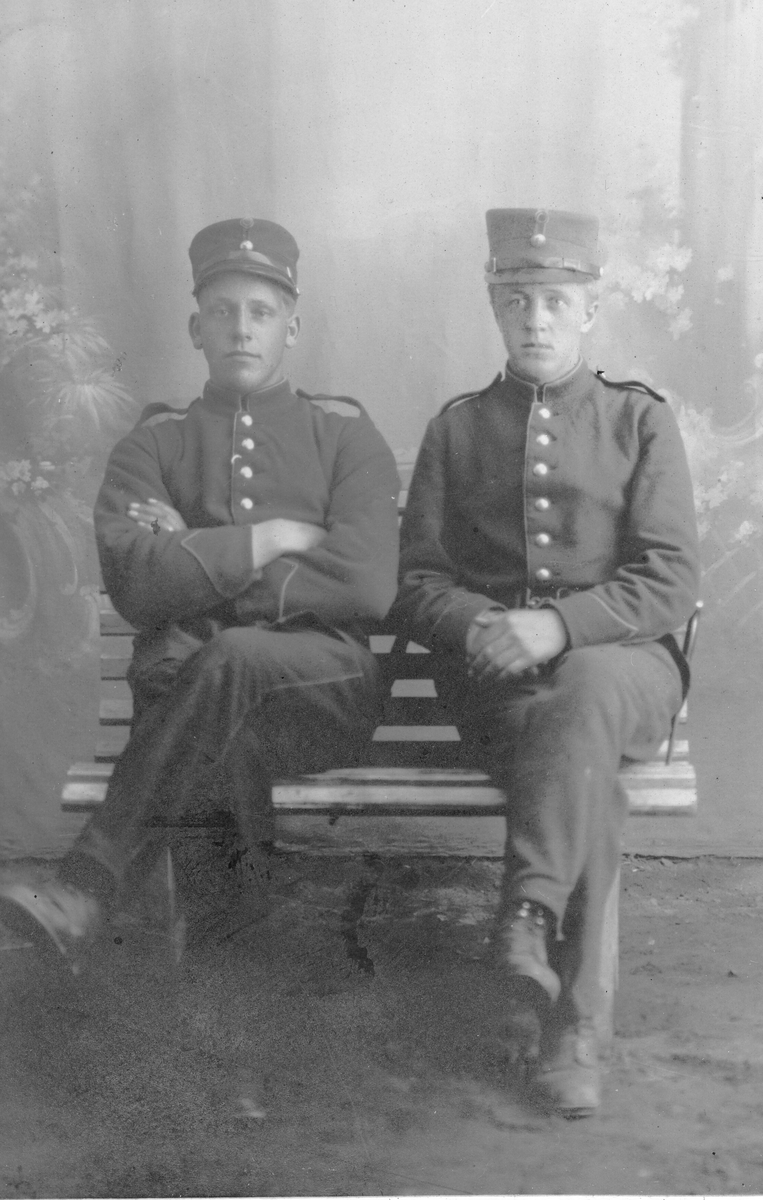 Visittkortfoto av to soldatar i fotoatelier.