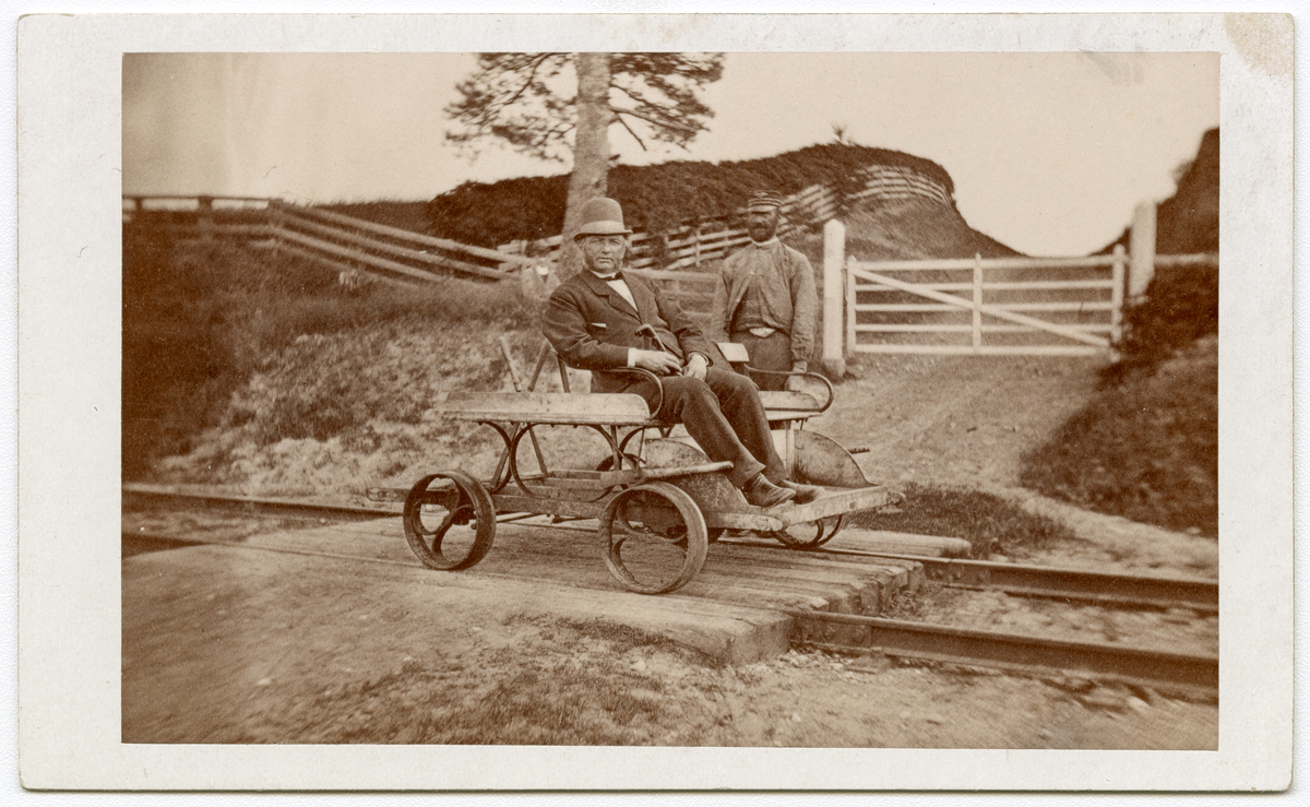 Antagelig foto av ingeniør på hovedbanen Christian Theiste, sittende på pumpedresin på jernbane, ca. 1875 - 1885