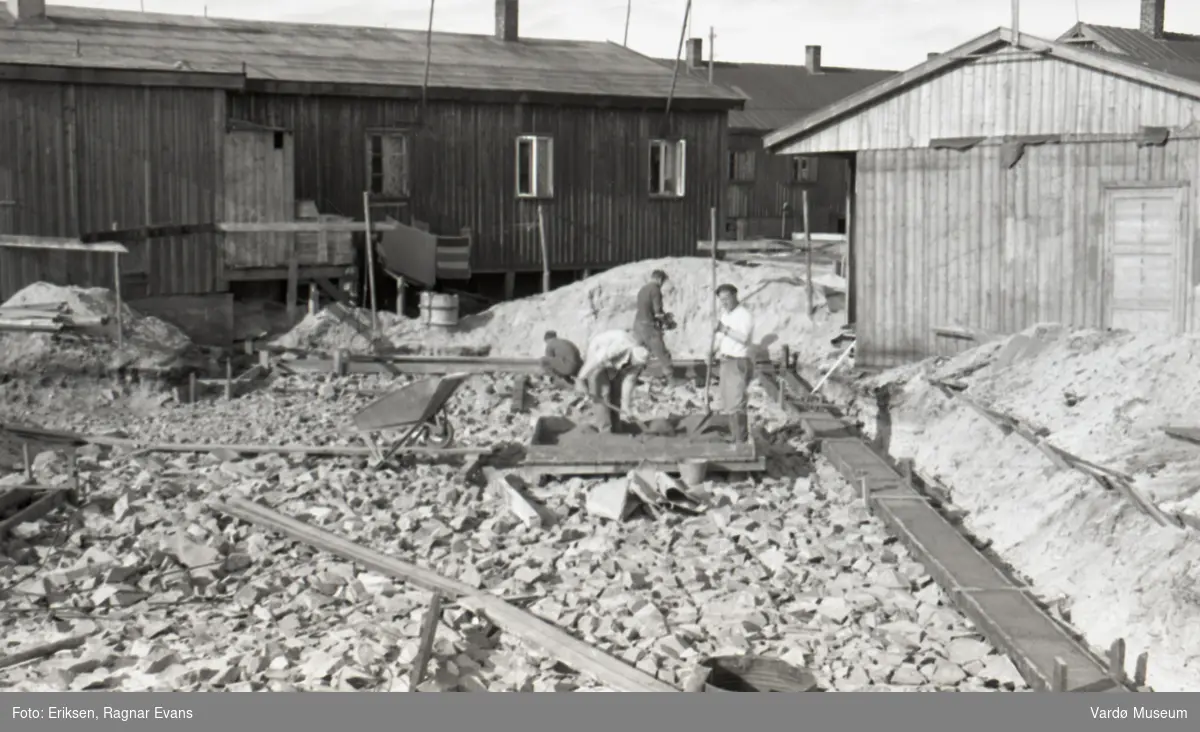 Byggearbeid, gjenreisningsarbeid i Vardø etter krigen. Antatt sted er bydelen som på folkemunne er kalt "Belsen", en ansamling av tyskerbrakker som folk bodde i etter krigen mens gjenreisningen pågikk.