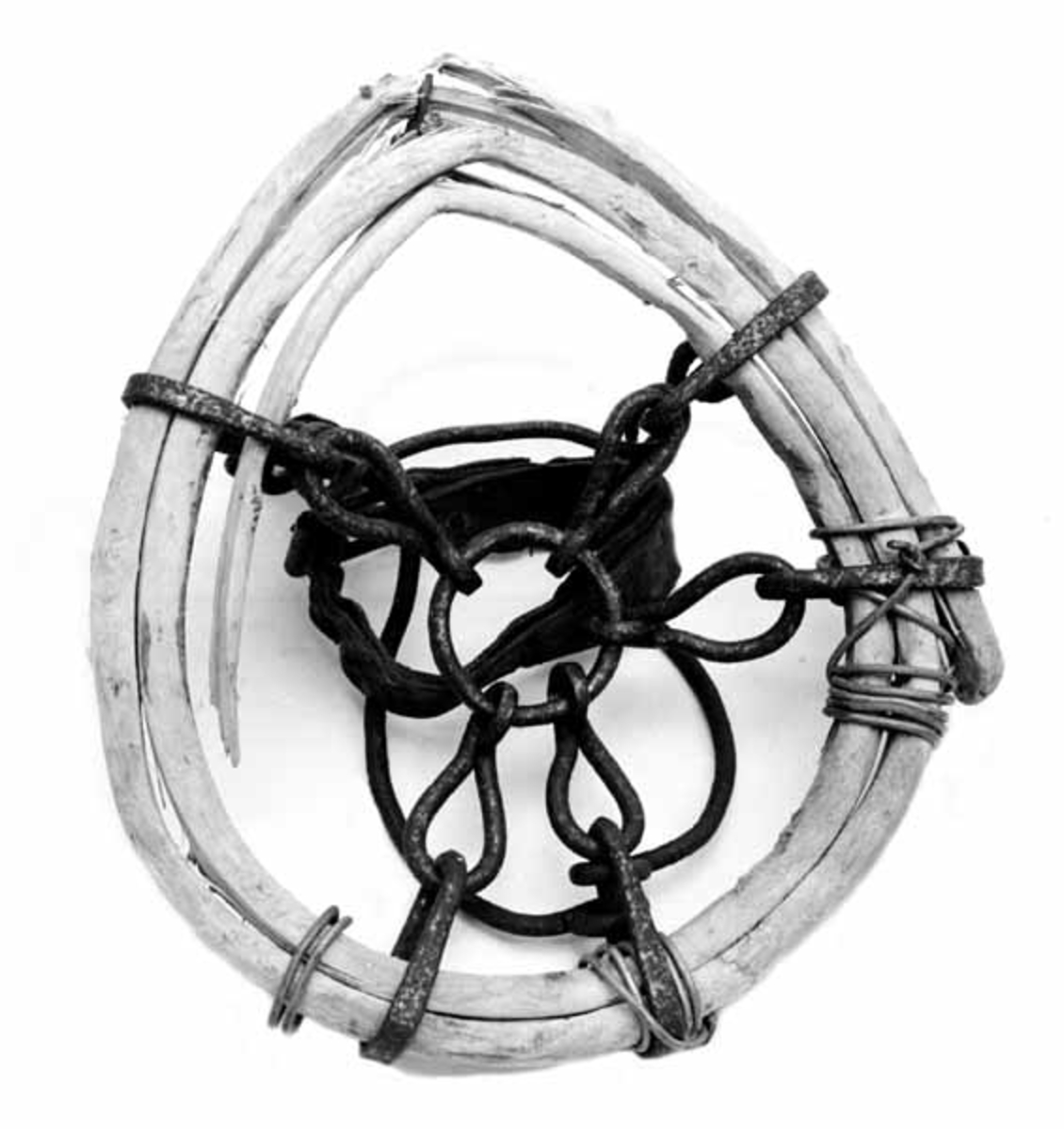 Hestetruge, lagd av tre, jern og lær. Den ytre ringen, som skulle gi hestehoven større bæreevne på sviktende underlag er lagd av en kvist fra et grantre. Kvisten er splittet i to i lengderetningen og viklet til en ring der deler av kvisten overlapper hverandre to, delvis tre ganger. Trekomponentene ble opprinnelig holdt ihop av fem ovale kjettinglekker med forbindelse til en jernring i sentrum av truga. Seinere har man sett seg nødt til å supplere disse sammenføyingene med ståltrådviklinger og en bøyd spiker. Spikeren har gnagd på treringen og ødelagt mange av trefibrene, noe som har resultert i at ringen ikke lenger er like rund som den en gang var.  Oppå truga er det festet to jernbøyler som igjen er forbundet av ei 3,3 centimeter bred lærreim med nålespenne. Disse bøylene og reime har tjent som festeanordninger rundt hestehoven.