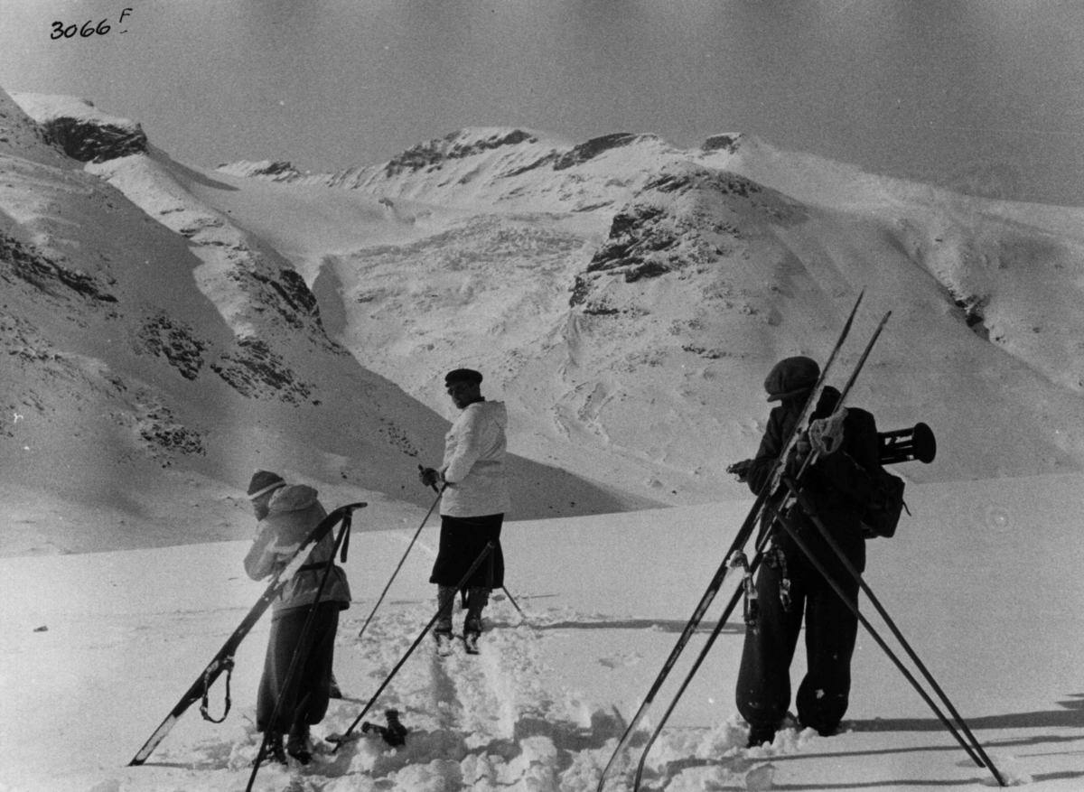 Skiløpere ved Galdhøpiggen i Jotunheimen med snødekte fjell og sol ...