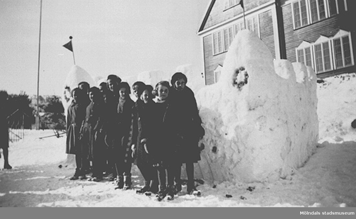 Fjärde året. Lärare: Sven Flodén, Barnen har friluftsdag och har byggt en snöfästning söder om gamla skolbyggnaden. Fotot märkt 4a1 på baksidan.