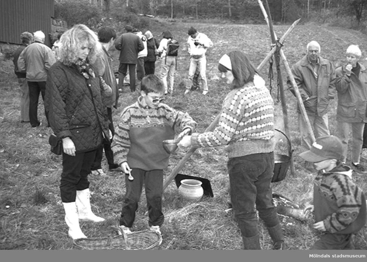 Familjesöndag vid Börjesgården, 1994-05-15. Museichef Mari-Louise Olsson lämnar en skål till en pojke och hans mor.