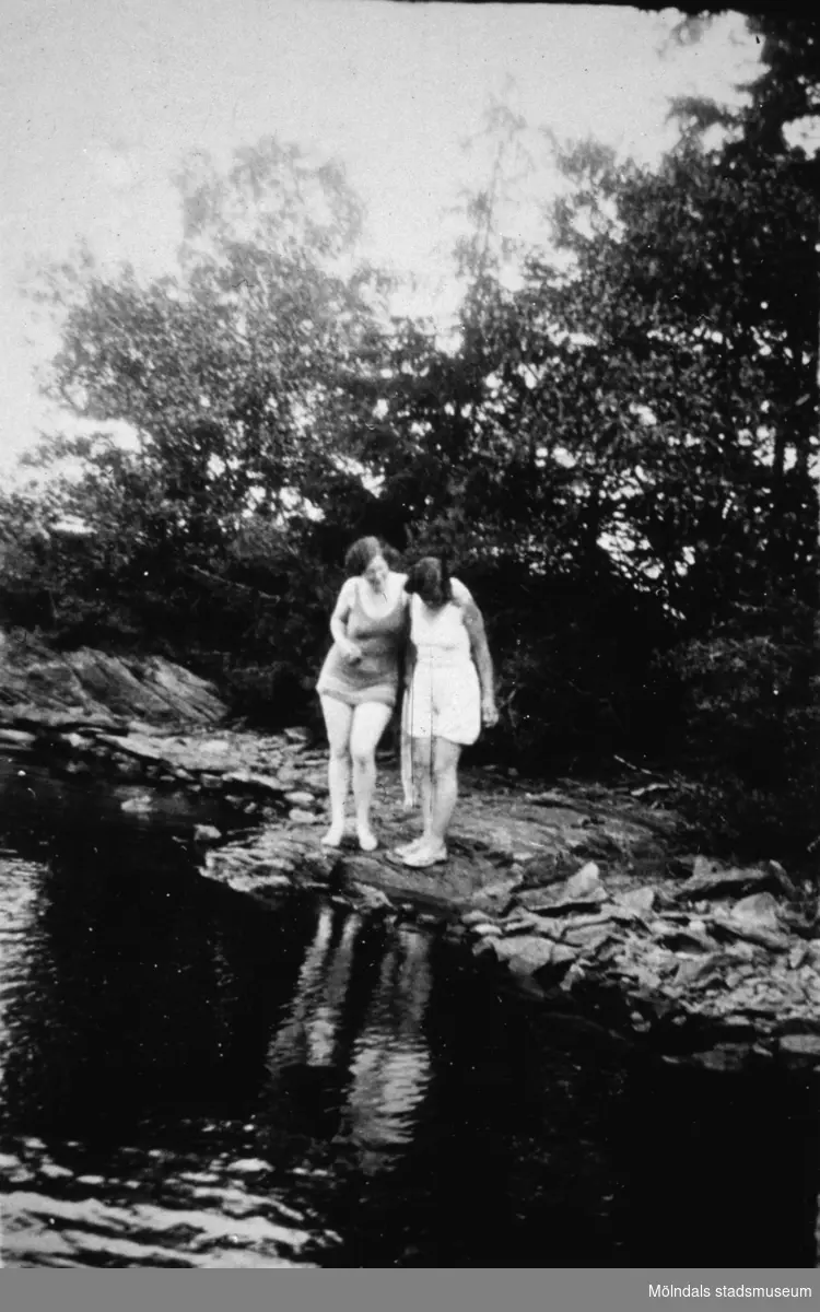 Två badklädda kvinnor står vid strandkanten, troligtvis vid Tulebosjön cirka 1930.
