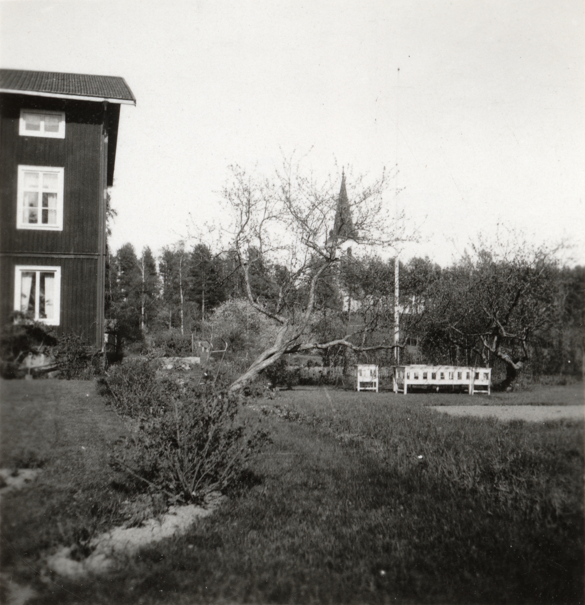 Utsikt från prästgården mot Mo kyrka. Prästgården var tidigare verkstadsbyggnad vid Flors Linnefabrik, Hälsingland. I sluttningen nedanför kyrkan låg små jordstugor där linet bereddes och vävning ägde rum.