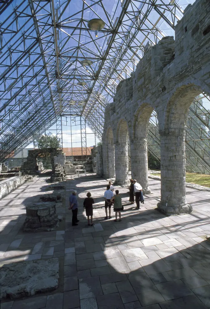 Massive medieval arches in limestone inside the glass catedral.