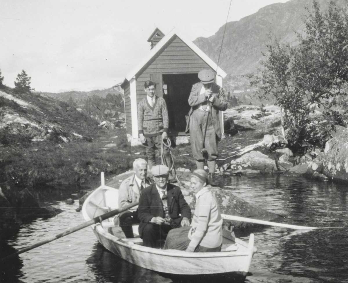 Frans Bruce med venner i robåt på eit fjellvatn.