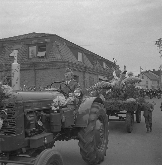 Linnéfestligheterna, 22/5-23/5 1957. 
Blomstertåget, 22 maj 1957. Parad på Storgatan med blomstervagnar m.m., vid nuv. Oxtorget. 
"Nils Holgersson" på sin gås hälsar på publiken.