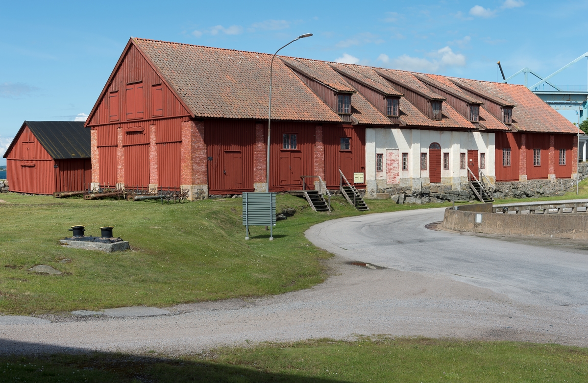 Fotodokumentation av byggnader på Lindholmen i Karlskrona. Granknäskjulet eller senare benämning knäskjulet. I denna byggnad handskades det med "knä" det var naturvuxna krokiga detaljer som användes vid skeppsbyggandet. Virkesskjul bakom granknäskjulet.
