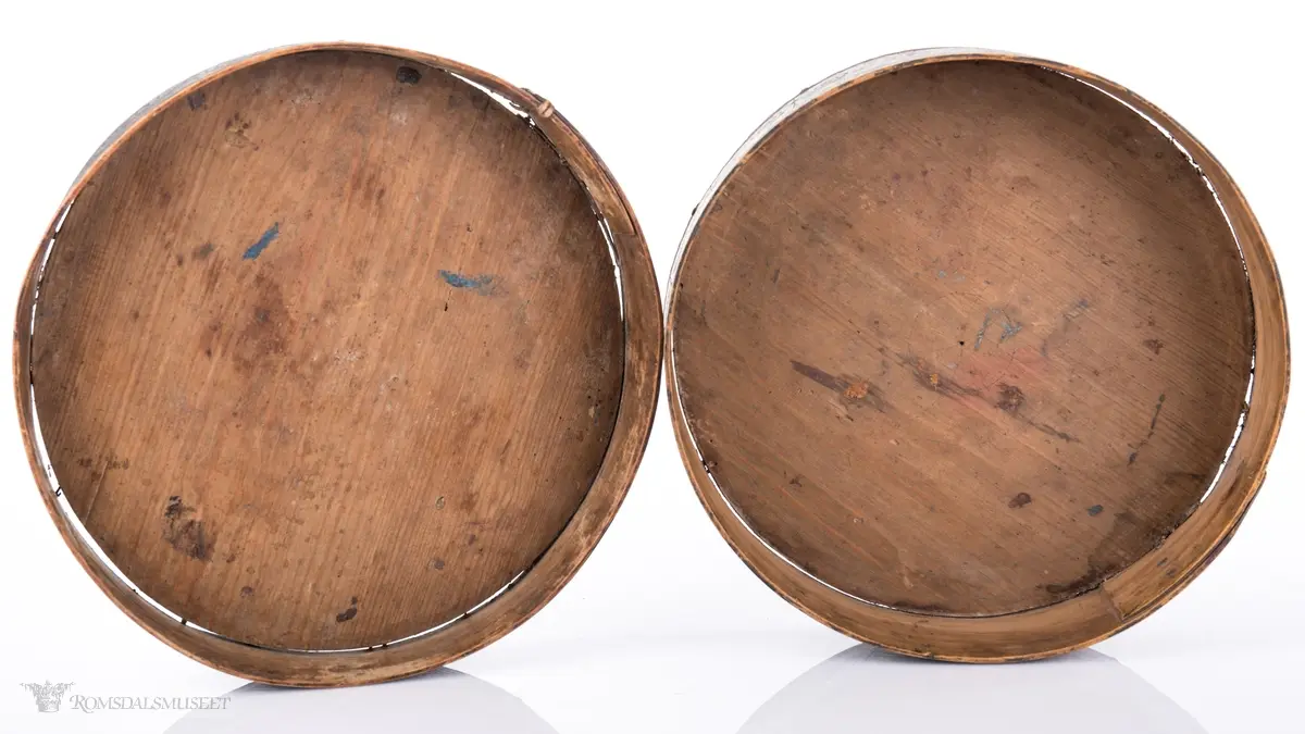 Seksbladsrose i karveskurd sammenkomponert med andre geometriske figurer sentralt på lokket. Dekorfelt rundt midten av lokket med kryss og spetter, N- formet bord o spetter ytterst. Lokktrosken har bølgeformede ranker. Små gjentagende blomsterbuketter på esketrosk. Innrisset passerrose i bunne  innvendig.