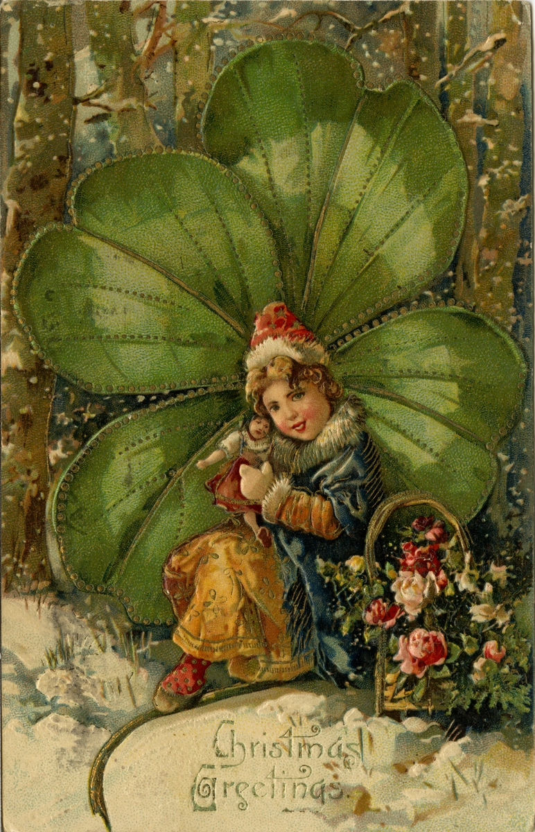 Julekort. Jule- og nyttårshilsen. Liten vinterkledd jente med dukke sitter foran en stor firkløver. Ved siden av henne står en kurv full av blomster. Engelsk tekst. Stemplet 7.12.1907.