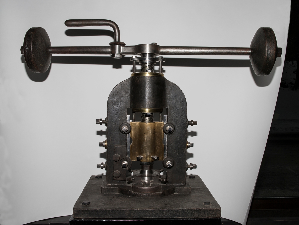 Maskin som brukes til å stanse ut rondeller / myntblanketter. Den har en svingarm med tykke skiver i enden. Svingarmen er festet øverst på en vertikal sylinder som har funksjonen å presse ut rondellene. Maskinen er montert på ett trebord som har en skuff og fire bein.