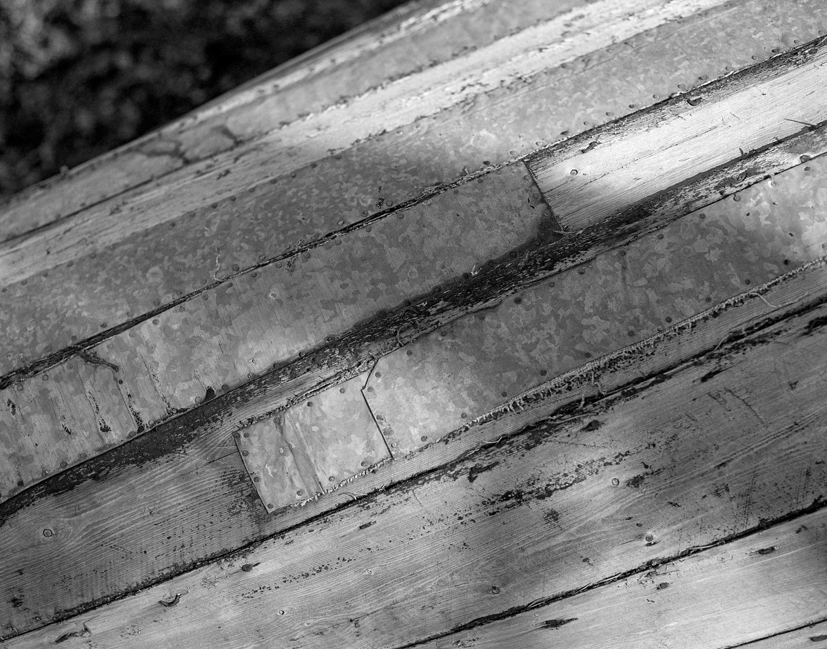 Reparert fløterbåt ved Trysilvassdraget våren 1986.  Båttypen som ble brukt her var forholdsvis lang og bred, men likevel lett.  Båten var lagd av forholdsvis tynne, smale furubord, som var sammenføyd ved hjelp av «kinger» - jernkramper.  På den avbildete båten hadde det tydeligvis oppstått spreker, som ble forsøkt reprerert ved å sitte på bøter av lange, rektangulære plater av sinkgalvanisert jernblikk, festet med småspiker langs ytterkantene.  Vi ser også spor av at farkosten har vært impregnert med tjære.