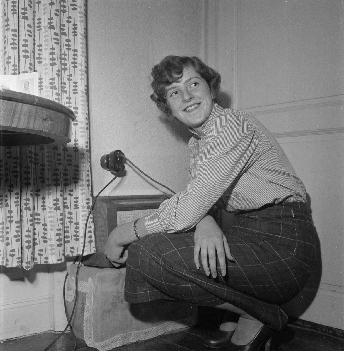 Kvinna sitter på huk, Uppsala 1954