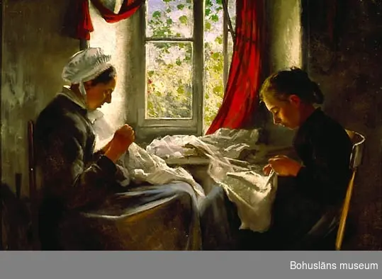 Kvinna och flicka handarbetar vid fönster
