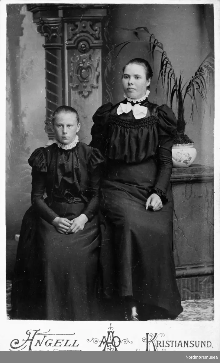 Foto av to unge kvinner. Trolig fra Kristiansund eller Nordmøre. Fra et fotoalbum som stammer etter Marie Opdal (f. april 1894 - d. februar 1981/82), og gitt i gave av Torbjørg og Arild Karijord. Fra Nordmøre museums fotosamlinger.