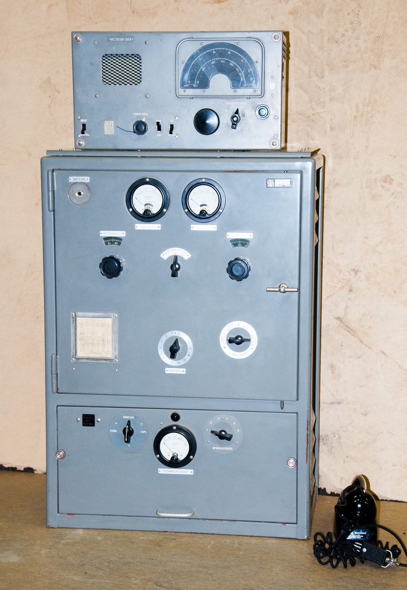 Marin radiostation, tre detaljer, med radiorör och mikrofon. 
Sändare AKH-4E, nr142. 
Mottagare ML-56, nr264 samt AKH-4P,nr500, Vikt: 72,0 + 70,0 + 13,0 kg, med
Telefonlur/mikrofon på väggfäste märkt: "Televerket långtongivare 06-16289 mått:L-95mm, B-88mm, H-150mm, kontakten på luren märkt: "microtelefon 06-12050 mikr. 35ohm"