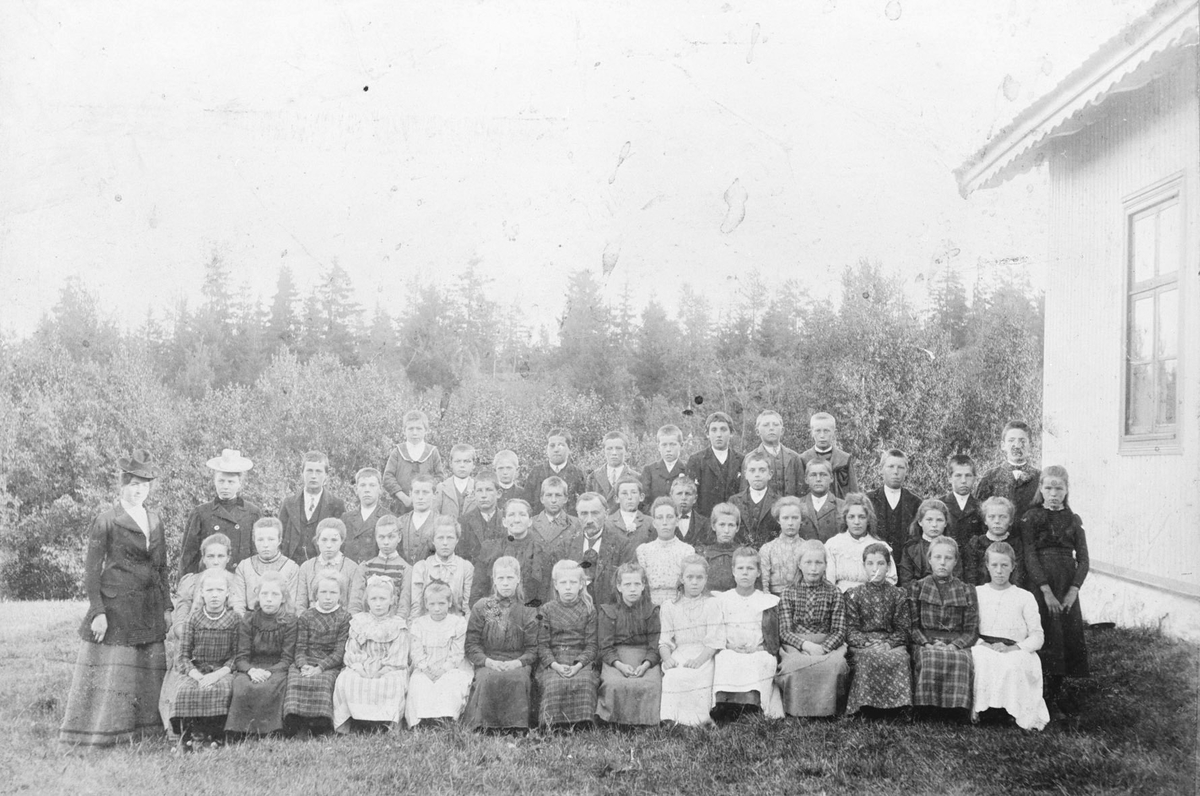 Lærere og skoleelever i sin fineste stas utenfor Åmodt skole på Nygard.