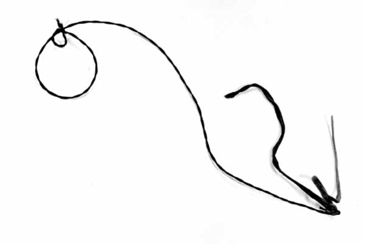 Snara er tvunnet av svart hestetagl. 
Ei lærreim til å feste snare med sitter i enden, med to 20 cm lange ender. 