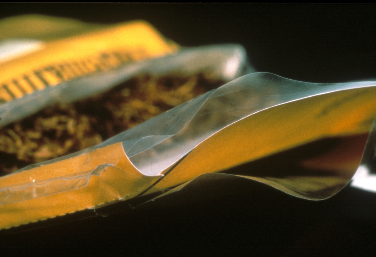 Reklamefoto av Tiedemanns gul mix tobakk. Fra billedserie til finsk kurs om gode råd for oppbevaring av tobakk fra 1981.