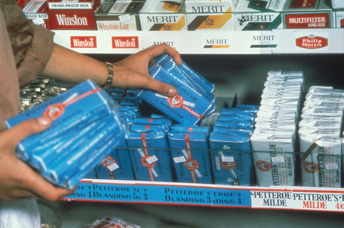 Butikkinteriør. Påfyll av tobakksvarer. Fra billedserie til finsk kurs om gode råd for oppbevaring av tobakk fra 1981.